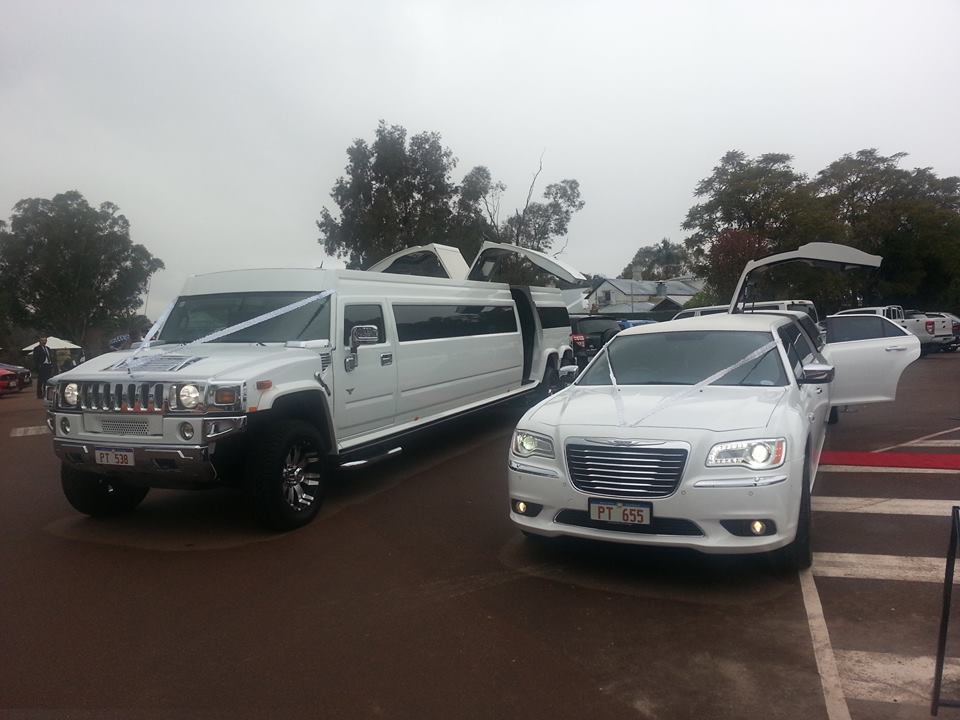 Hummer and Chrysler limo parked in lot