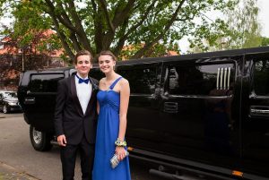 Prom couple posed with black hummer limo