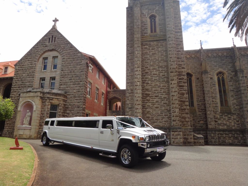 Hummer limo wedding in front of a church