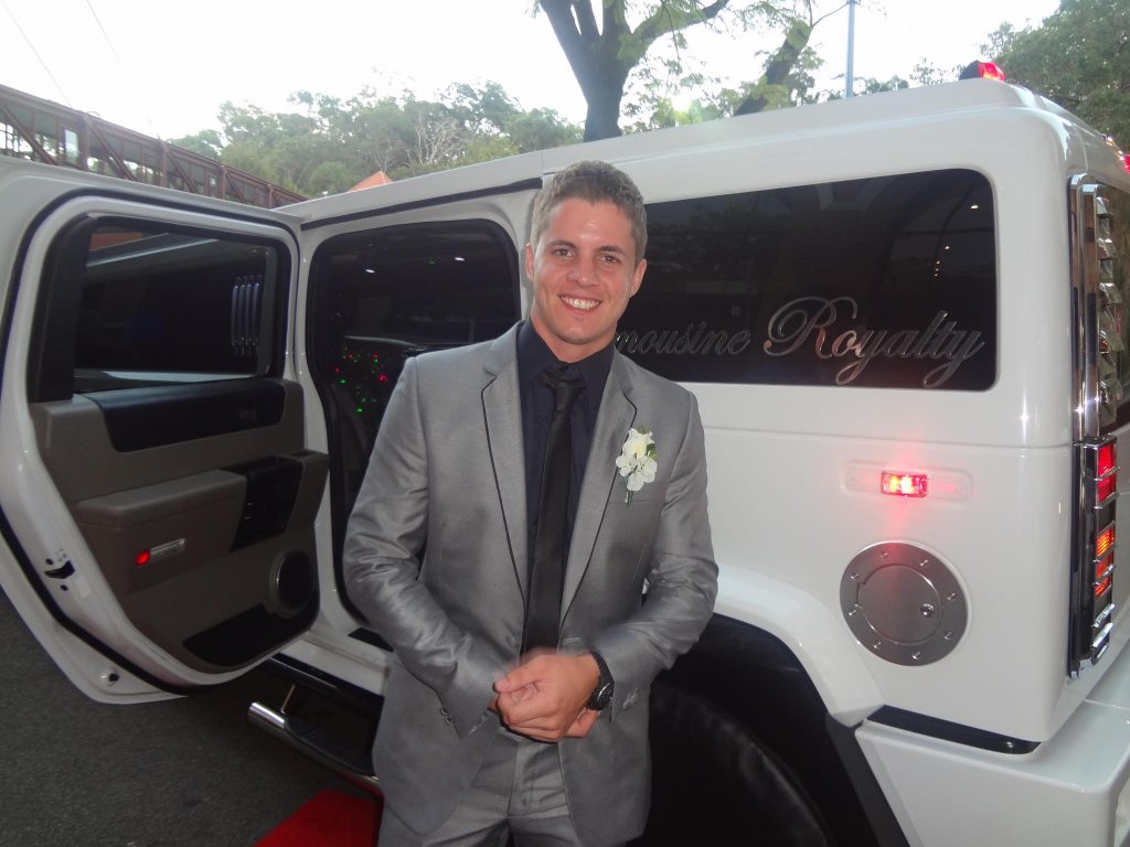 Man standing in front of stylish limo