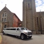 A brand new wedding Hummer outside of a church
